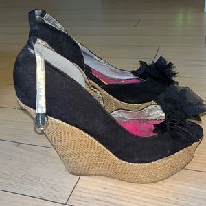 Cute peep toe wedges with flower like detail at peep toe.